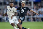 Los Angeles FC's Kellyn Acosta (23) saves a potential goal by Minnesota United's Emanuel Reynoso during stoppage time in an MLS soccer match Tuesday, 