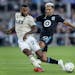 Los Angeles FC's Kellyn Acosta (23) saves a potential goal by Minnesota United's Emanuel Reynoso during stoppage time in an MLS soccer match Tuesday, 