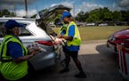 Volunteers distribute groceries to families in need outside a food pantry in Houston on Aug. 5. A second year of emergency pandemic aid from the feder