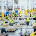 Employees at Amazon’s sorting center in Woodbury last week. Amazon opened the 525,000-square-foot building, visible from Interstate 94, in August.