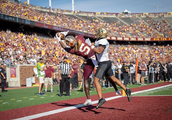 Dylan Wright (5) caught a touchdown pass for the Gophers, despite tight coverage from Colorado’s Kaylin Moore (0) on Sept. 17, 2022 at Huntington Ba