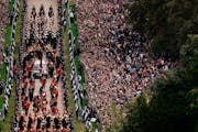 The ceremonial procession of Queen Elizabeth II’s coffin arrives at Windsor Castle on Monday.