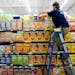 Wes Stevenson climbed a ladder to perfect the cereal display in Fayetteville, Ark., Oct. 12, 2016.