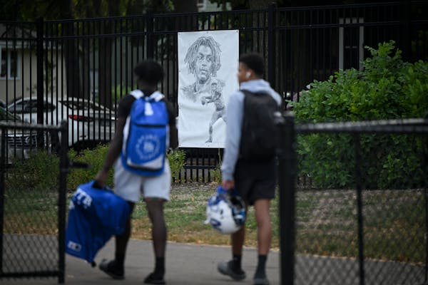 When they enter and leave Minneapolis North’s football field, players walk by an image of Deshaun Hill, a teammate who was shot to death in February