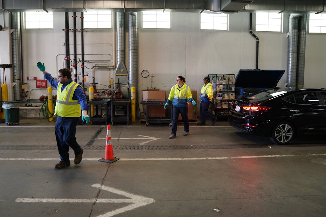 Workers waved cars into Hennepin County's Bloomington hazardous waste facility in 2019.