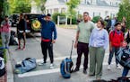 Migrants, who arrived on a flight sent by Florida Gov. Ron DeSantis, gather with their belongings outside St. Andrews Episcopal Church, on Sept. 14 in