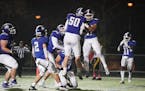 Woodbury running back Isaiah Tisdle (21) and offensive lineman Keaton Brown (50) celebrated Tisdle’s third quarter touchdown against Burnsville.