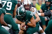 Michigan State quarterback Payton Thorne is sacked by the Gophers’ Ryan Stapp during the first quarter Saturday.