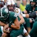Michigan State quarterback Payton Thorne is sacked by the Gophers’ Ryan Stapp during the first quarter Saturday.