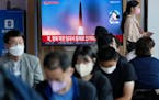 A file image of a missile launch by North Korea is shown on a news program at the Seoul Railway Station in Seoul, South Korea, Sunday, Sept. 25, 2022.