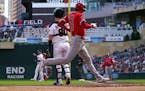 Shohei Ohtani scores on a single by Matt Thaiss in the first inning Sunday at Target Field