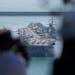 U.S. aircraft carrier USS Ronald Reagan is escorted into Busan Naval Base in Busan, South Korea, Friday, Sept. 23, 2022. The USS Ronald Reagan arrived
