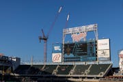 Construction cranes are working behind Target Field for the North Loop Green building that will be completed by 2024.