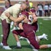 Gophers coach P.J. Fleck, shown here hugging punter Mark Crawford, is calling on fans, boosters, alumni and others to support Minnesota athletes via D