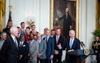 President Joe Biden, at lectern, welcomed Terry McGuirk, chairman and chief executive, left, and the 2021 World Series champions Atlanta Braves to the