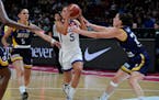 Kelsey Plum runs between Bosnia and Herzegovina’s Miljana Dzombeta, left, and Andela Delic, right, during their game at the women’s Basketball Wor