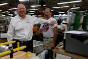 Jay Lund, CEO of Andersen Corp., laughed with an employee in the company’s Bayport plant in 2013.