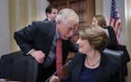 Sen. Angus King, I-Maine, left, confers with Sen. Amy Klobuchar, D-Minn., chair of the Senate Rules Committee, as the panel meets on the Electoral Cou