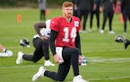 Saints quarterback Andy Dalton stretched during practice at the London Irish rugby team training ground near London on Wednesday.