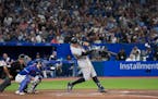 New York Yankees’ Aaron Judge hits a two-run home run, his 61st homer of the season during the seventh inning Wednesday in Toronto