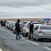 People walk next to their cars queuing to cross the border into Kazakhstan about 250 miles south of Chelyabinsk, Russia, on Tuesday. Officials say abo