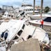 A man took photos of boats damaged by Hurricane Ian in Fort Myers, Fla., on Thursday.