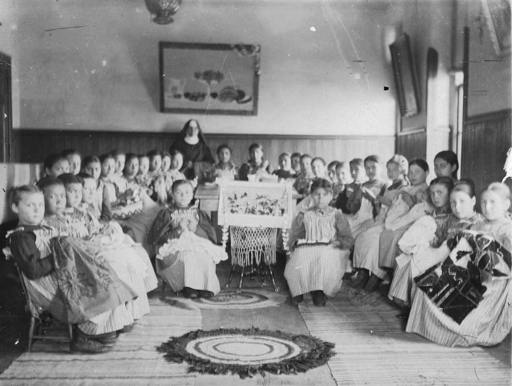 Students hold craft projects at the St. Benedict's Mission School on the White Earth Indian Reservation in the 1890s.