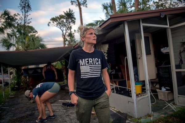 Keisha Boyd, with the United Cajun Navy, outside the home of a man who ran out of oxygen due to a power outage caused by Hurricane Ian at the Hideaway