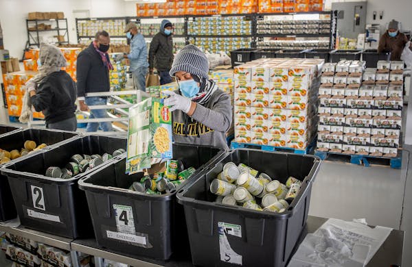 Workers at Brava Cafe in Minneapolis packed seven days worth of packaged meals on Feb. 4, 2022. The federal waivers allowing distribution of meals tha