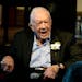 Former President Jimmy Carter reacts as his wife Rosalynn Carter speaks during a reception to celebrate their 75th wedding anniversary Saturday, July 