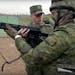 In this handout photo taken from video released by Russian Defense Ministry Press Service, Russian recruiters attended a military training at the Patr