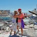 Muralist Candy Miller, left, embraced Ana Kapel, manager of the Pier Peddler gift shop and women’s clothing store, amid its ruins on Fort Myers Beac