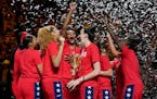 United States players held their trophy as they celebrated on the podium after defeating China in the gold medal game at the World Cup in Sydney on Sa