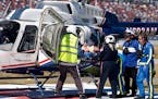 Driver Jordan Anderson is loaded into a helicopter after a fiery crash during the NASCAR Trucks Chevrolet Silverado 250 
