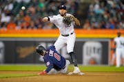 Tigers second baseman Harold Castro threw to first base over the Twins’ Jake Cave for a double play hit into by Gary Sanchez during the fourth innin