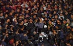 Soccer fans chant slogans during vigil for the victims of Saturday’s soccer riots, in Malang, East Java, Indonesia, Sunday, Oct. 2, 2022. Police fir