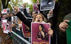 Protesters demonstrate during the global protest against the Iranian regime in front of the Iranian embassy in Bern, Switzerland, Saturday, Oct. 1, 20