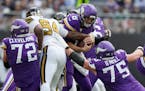 Vikings quarterback Kirk Cousins (8) was sacked three times against the Saints in London on Sunday. 