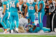 Miami Dolphins quarterback Tua Tagovailoa (1) is attended by medical staff after being sacked by Cincinnati Bengals defensive tackle Josh Tupou during