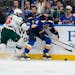 St. Louis Blues’ Nick Leddy chases after a loose puck along the boards as the Wild’s Sam Steel defends during the first period Tuesday