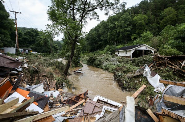 Debris from destroyed homes piled up near a concrete bridge over Grapevine Creek in Perry County after torrential rain caused flash flooding in Easter