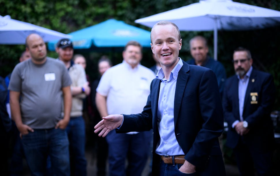 Republican attorney general candidate Jim Schultz speaks to a group of law enforcement officials and supporters during a campaign event on Sept. 29 in