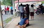 In this image taken from video, a distraught woman is comforted outside the site of an attack at a daycare center, Thursday, Oct. 6, 2022, in the town