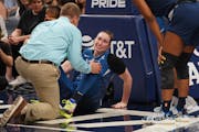 Lynx trainer Chuck Barta, left, attended to Jessica Shepard after Shepard injured her knee in a June 2019 game.
