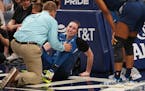 Lynx trainer Chuck Barta, left, attended to Jessica Shepard after Shepard injured her knee in a June 2019 game.