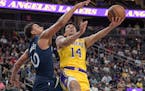 Lakers guard Scotty Pippen Jr. tried to get off a shot against Timberwolves guard Bryn Forbes during the first half of the Wolves’ 114-99 victory Th