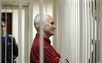 Ales Bialiatski, the jailed leader of Vesna, the most prominent human rights group in Belarus, stands in a cage during a court session in Minsk, Belar