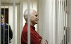 FILE- Ales Bialiatski, the jailed leader of Vesna, the most prominent human rights group in Belarus, stands in a cage during a court session in Minsk,
