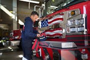 Paid on-call firefighter Valen Watson checked safety equipment Saturday, Oct. 8, at Bloomington’s Fire Station 1. The department just received a $6.