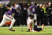 Minnesota Vikings cornerback Cameron Dantzler Sr. (3) reaches out to get a hand on Chicago Bears quarterback Justin Fields (1) as he rushed the ball i